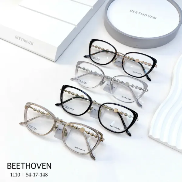 BEETHOVEN 1111 cat-eye frames with a beaded chain along the titanium temple, in black tortoise, clear champagne and navy with pearl beads