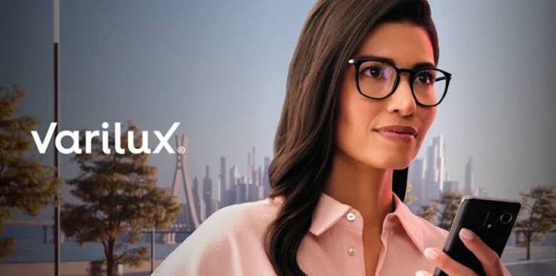 Woman wearing glasses with Essilor Varilux multifocal lenses in an outdoor urban setting